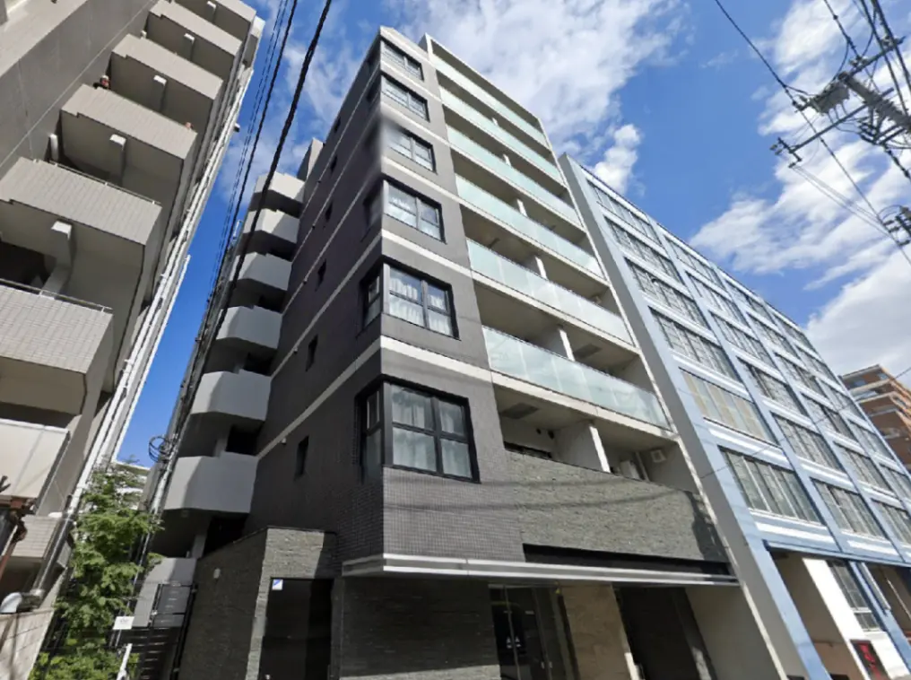- 現代的なデザインの高層マンション、ガラスのバルコニーとシックな外観、青空を背景にした街並みの写真